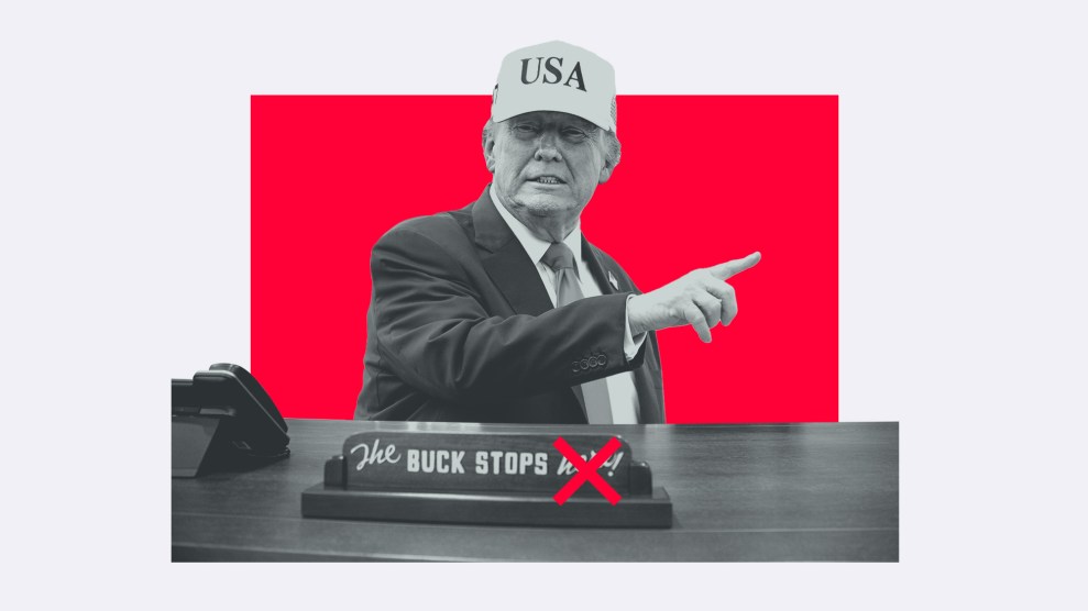 A photo illustration of Donald Trump in a 'USA' hat, pointing his finger. On the desk before him, a sign reads 'The Buck Stops here!' with the word 'here' crossed out in red against a red background.